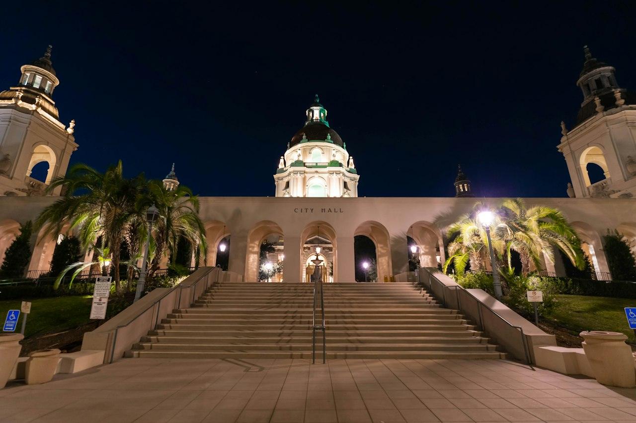 Pasadena City Hall's domed tower and courtyard stairs lit at night