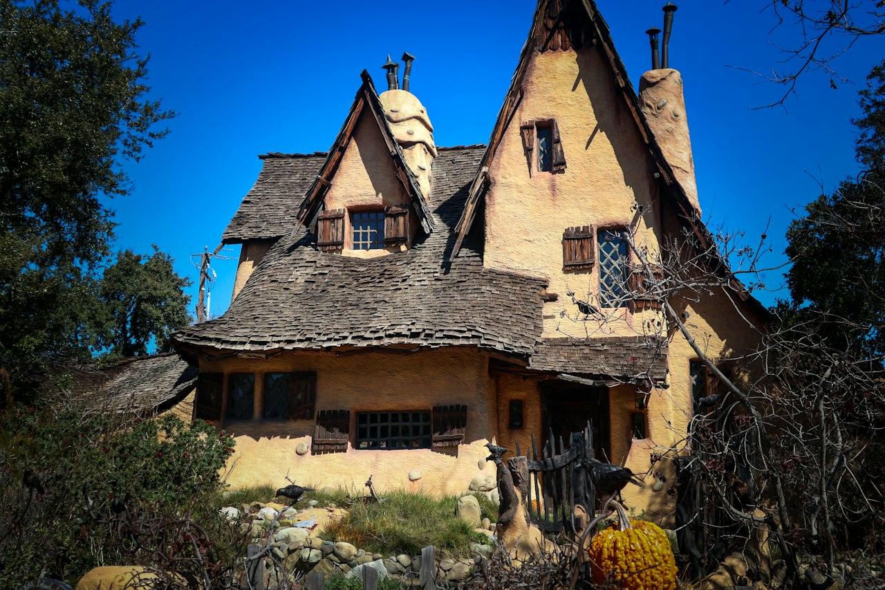 The Spadena House, known as the Witch's House, in Beverly Hills, with sharply peaked, uneven shingle roofs and crooked shuttered windows